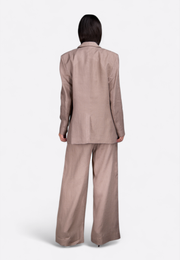 Back view of model wearing beige linen blazer, East Vibe